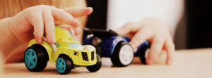 Child playing with toy cars